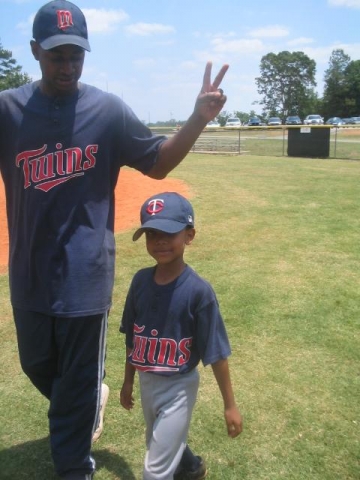 One of the TWINS (Andy Parker) with his son protege - lil twin Angelo Parker.... That kid is going to the majors! 